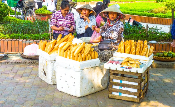 Vietnamese women selling baguette